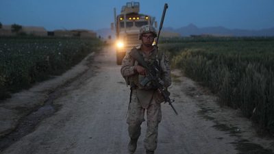 PATROL BASE SHARK, Helmand province, Islamic Republic of Afghanistan – An infantryman with 3rd Battalion, 4th Marine Regiment, helps escort a combat vehicle full of supplies for an observation post. The Combined Anti-Armor Teams with the unit frequently make trips to several posts around their area of operations on re-supply missions. 2nd Marine Division Photo by Cpl. Marco Mancha Date Taken:04.25.2011 Location:PATROL BASE SHARK , HELMAND PROVINCE, ISLAMIC REPUBLIC OF, AF. Via Wikimedia Commons.